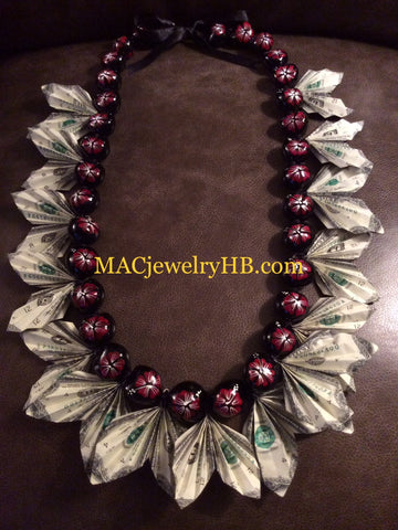 Red hand painted Kukui Nut Money Lei. It’s make with 15x$1.00 bills
